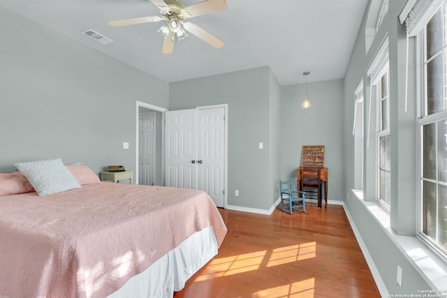 bedroom with ceiling fan and hardwood / wood-style flooring