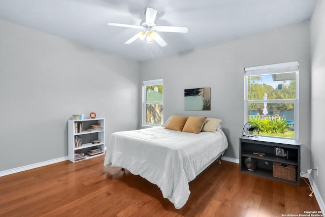 bedroom featuring ceiling fan and dark hardwood / wood-style flooring