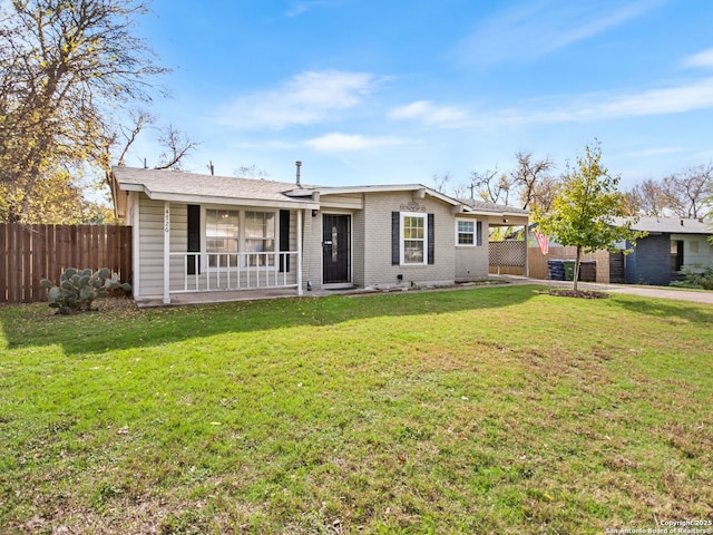 ranch-style home featuring a front yard