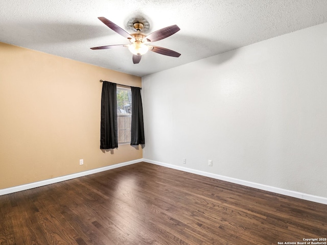 spare room with dark hardwood / wood-style floors, ceiling fan, and a textured ceiling