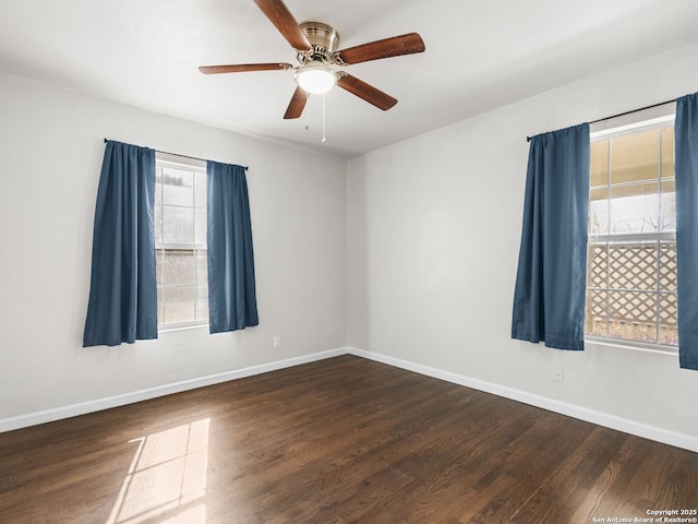 spare room with ceiling fan and dark wood-type flooring