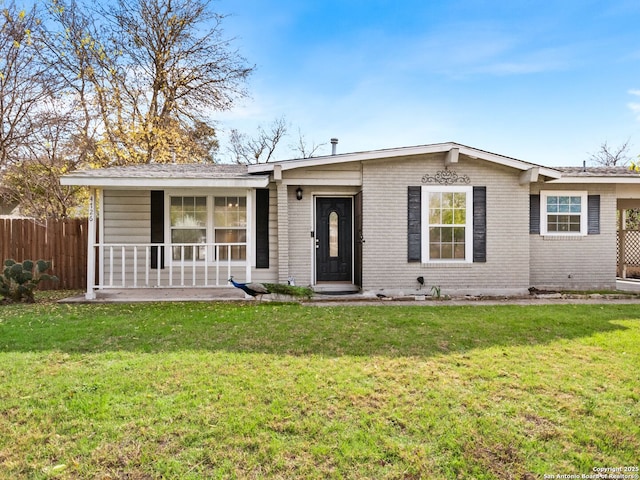 ranch-style house featuring a porch and a front lawn