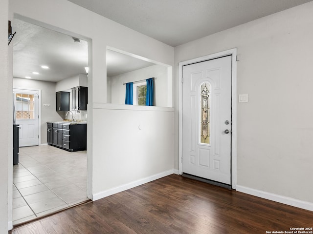 entryway with hardwood / wood-style floors and sink