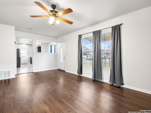 interior space with wood-type flooring and ceiling fan with notable chandelier