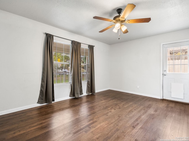 unfurnished room with a textured ceiling, dark hardwood / wood-style flooring, and ceiling fan