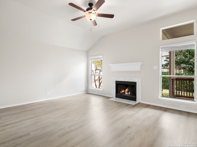 unfurnished living room featuring light hardwood / wood-style flooring, vaulted ceiling, and ceiling fan