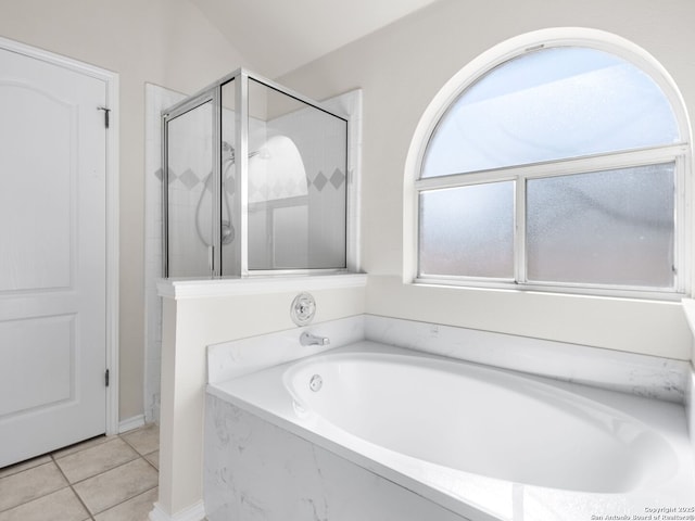 bathroom featuring plus walk in shower and tile patterned flooring