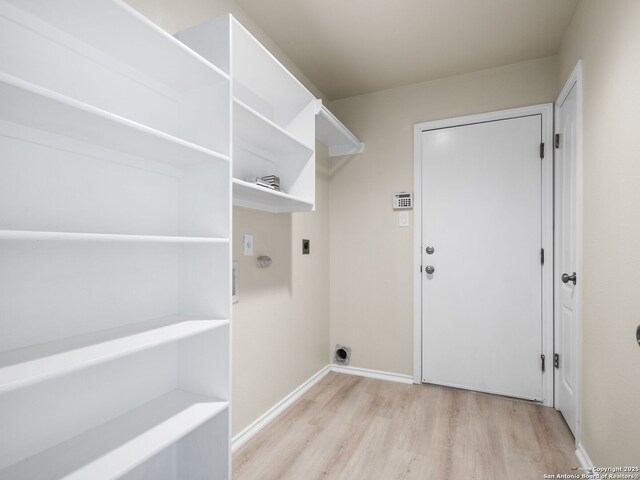 laundry room with light hardwood / wood-style floors and electric dryer hookup