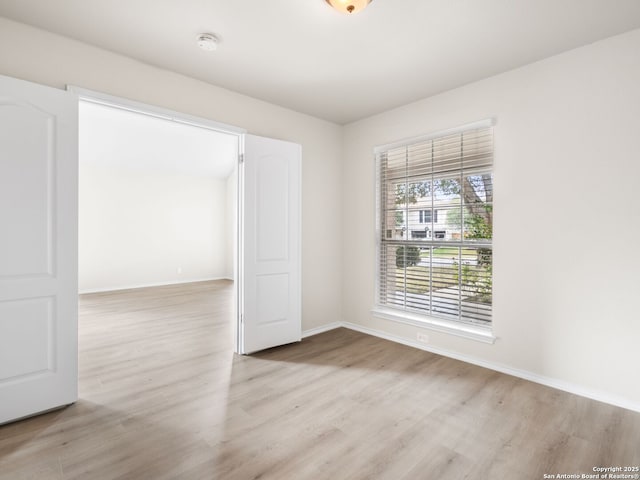 spare room featuring light wood-type flooring