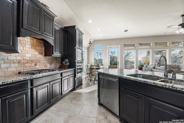 kitchen featuring sink, ceiling fan, light tile patterned floors, tasteful backsplash, and stainless steel appliances