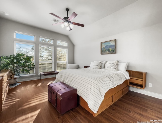 bedroom featuring dark hardwood / wood-style floors, vaulted ceiling, and ceiling fan