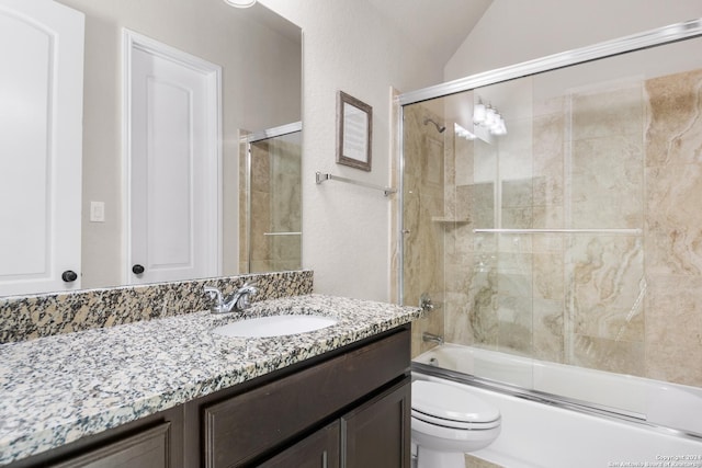 full bathroom with vanity, toilet, shower / bath combination with glass door, and vaulted ceiling