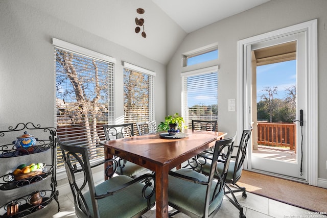 tiled dining area with vaulted ceiling