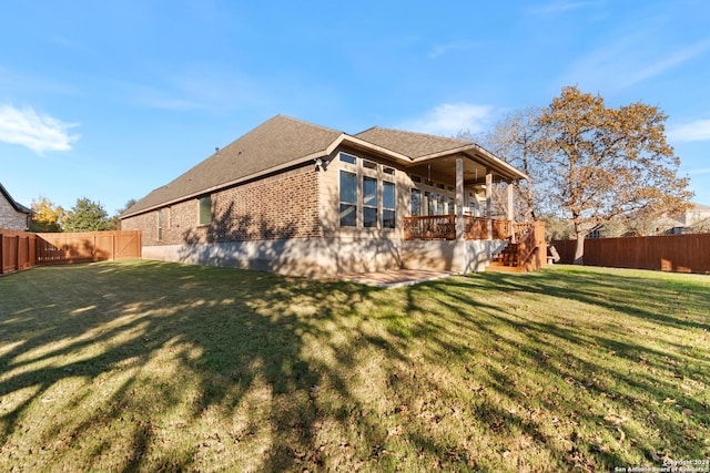 rear view of property with a lawn