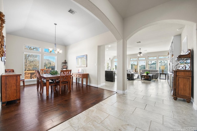 dining area featuring ceiling fan with notable chandelier and light hardwood / wood-style flooring