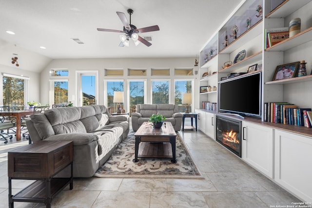 living room featuring ceiling fan and vaulted ceiling