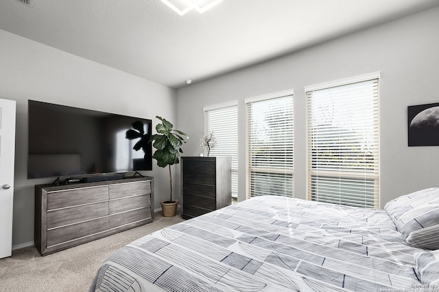 bedroom featuring light colored carpet