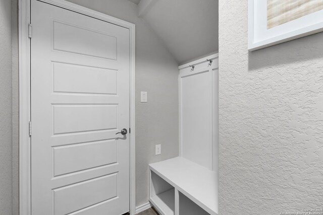 mudroom featuring vaulted ceiling