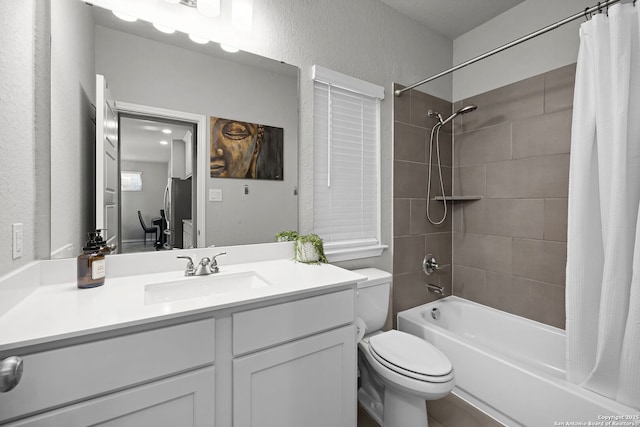 full bathroom with shower / bath combo, vanity, and toilet