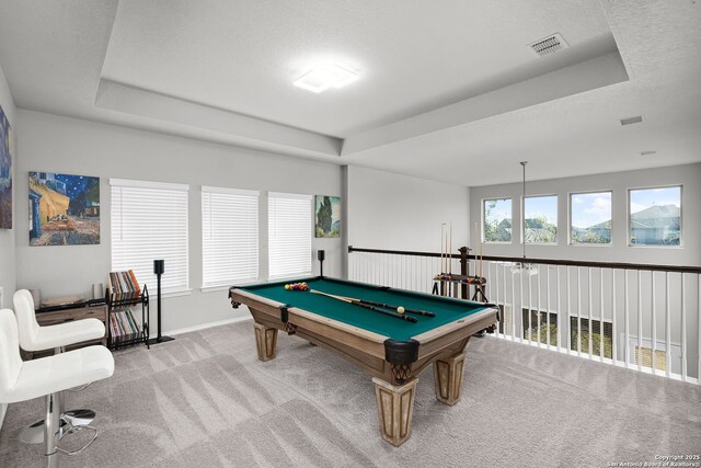 recreation room with a tray ceiling, light carpet, and pool table