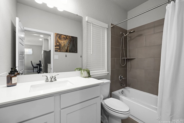 full bathroom with vanity, shower / bath combo, and toilet