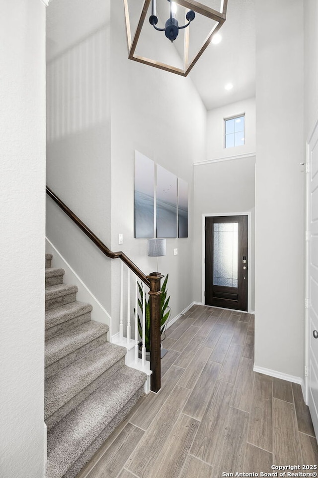 entryway with a high ceiling and an inviting chandelier