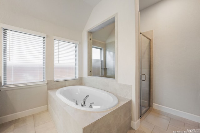 bathroom featuring separate shower and tub, tile patterned flooring, and vaulted ceiling