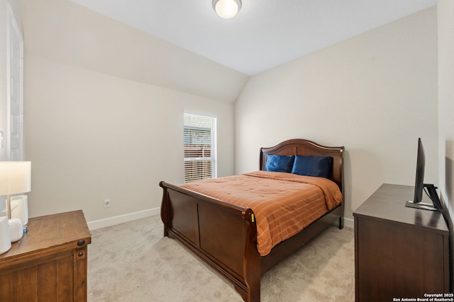 carpeted bedroom featuring lofted ceiling