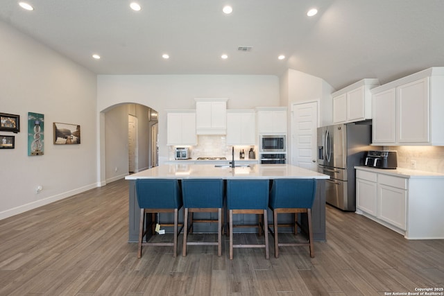 kitchen featuring white cabinetry, a spacious island, and appliances with stainless steel finishes