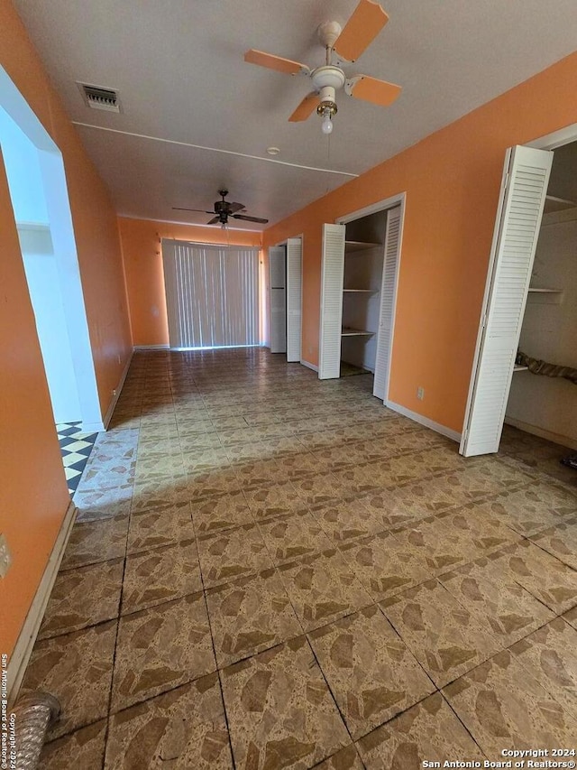 unfurnished living room with ceiling fan