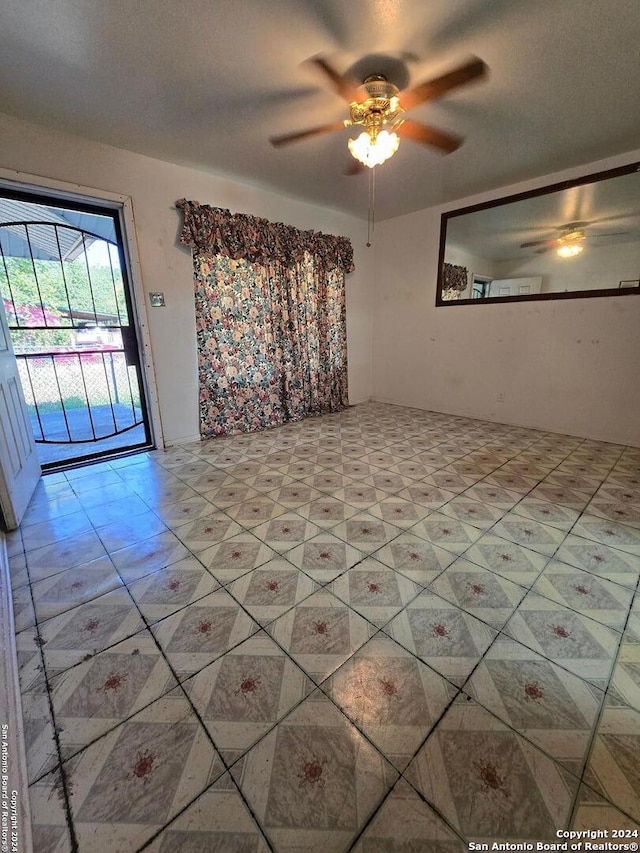 unfurnished room with ceiling fan