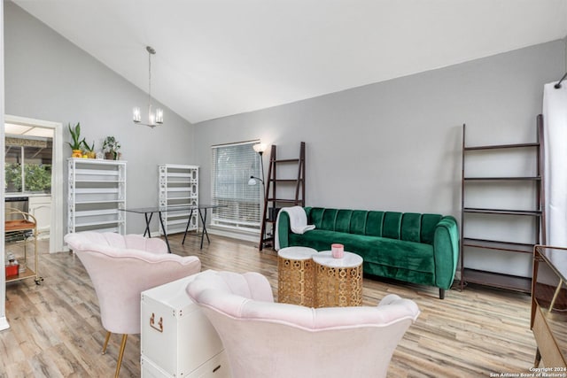 living room featuring hardwood / wood-style floors, lofted ceiling, and an inviting chandelier