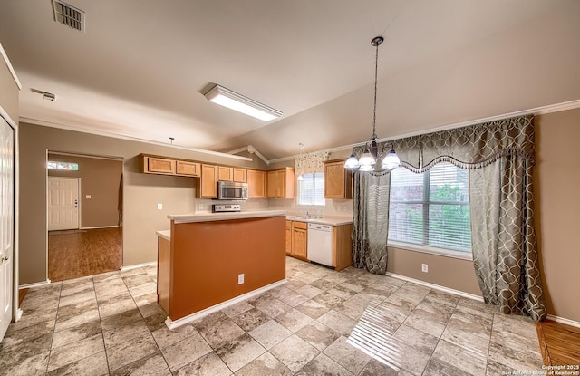 kitchen with dishwasher, a center island, hanging light fixtures, and a wealth of natural light