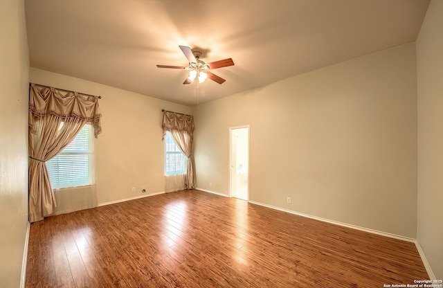 unfurnished room with ceiling fan, a healthy amount of sunlight, and wood-type flooring