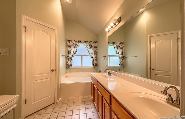 bathroom featuring tile patterned floors, vanity, vaulted ceiling, and a bathing tub