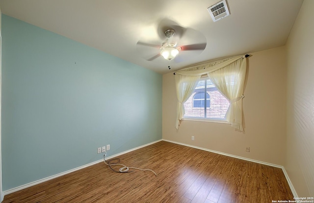 unfurnished room with ceiling fan and wood-type flooring