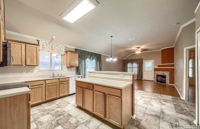 kitchen with a wealth of natural light, a fireplace, hanging light fixtures, and vaulted ceiling