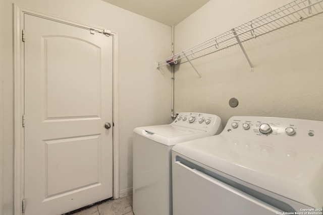 washroom featuring independent washer and dryer and light tile patterned floors