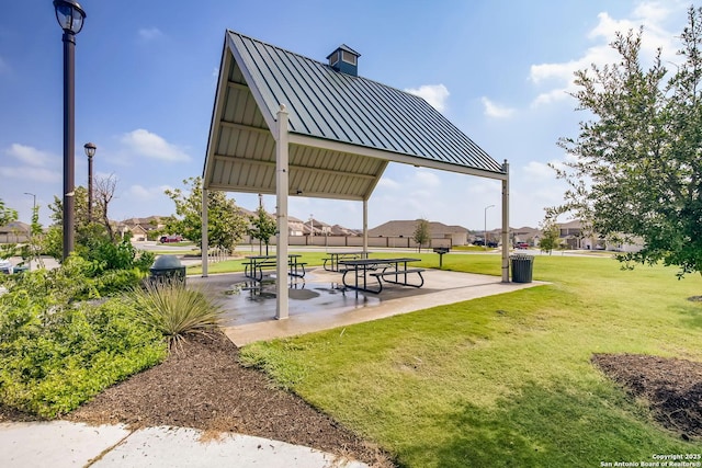 surrounding community with a lawn and a patio area