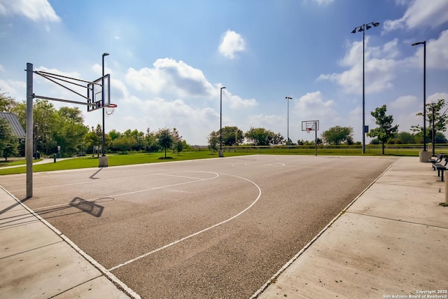 view of sport court featuring a lawn