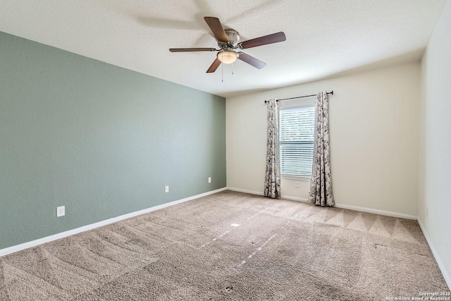 carpeted empty room featuring ceiling fan and a textured ceiling