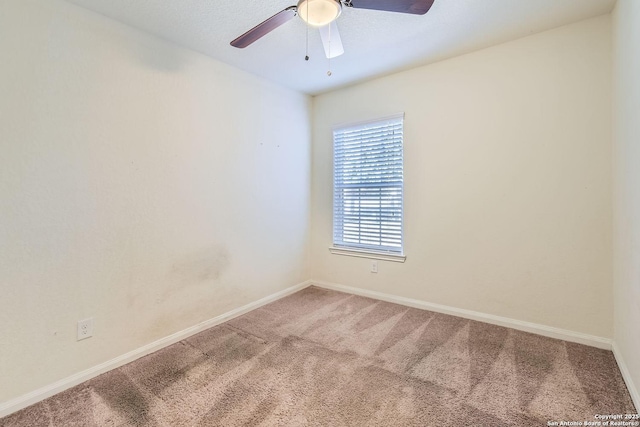 empty room featuring carpet and ceiling fan