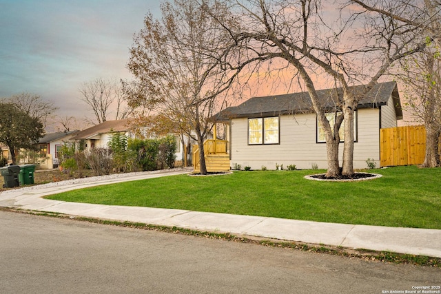 single story home featuring a yard