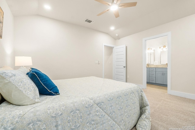 bedroom with ensuite bath, ceiling fan, light colored carpet, and lofted ceiling