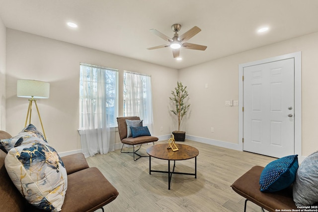 sitting room with light wood-type flooring and ceiling fan