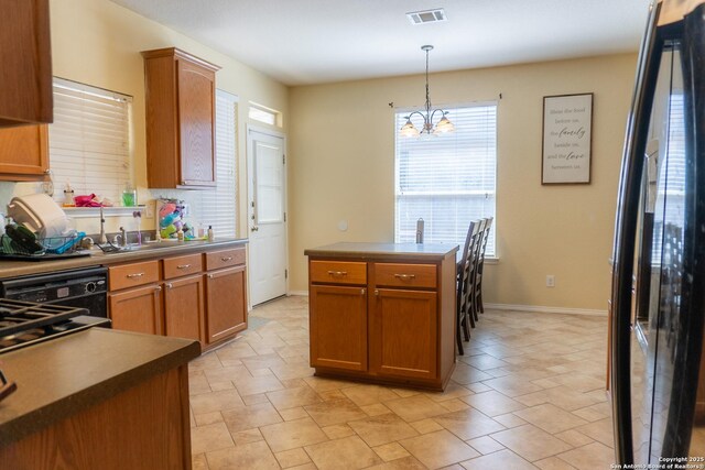 755 Eagles Gln, Schertz, TX 78108 - kitchen with a sink, decorative light fixtures, black appliances, a chandelier, and brown cabinetry