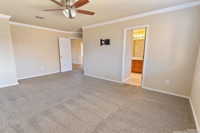 spare room featuring light carpet, ceiling fan, and crown molding