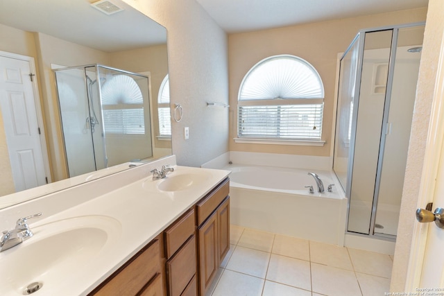 bathroom with tile patterned floors, vanity, and plus walk in shower