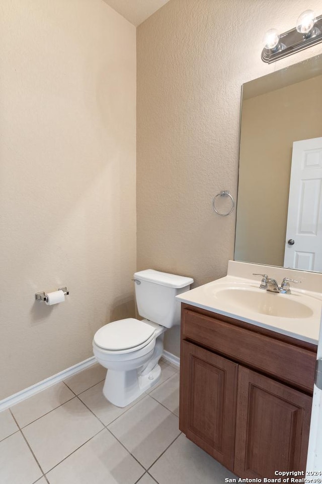 bathroom with tile patterned floors, vanity, and toilet