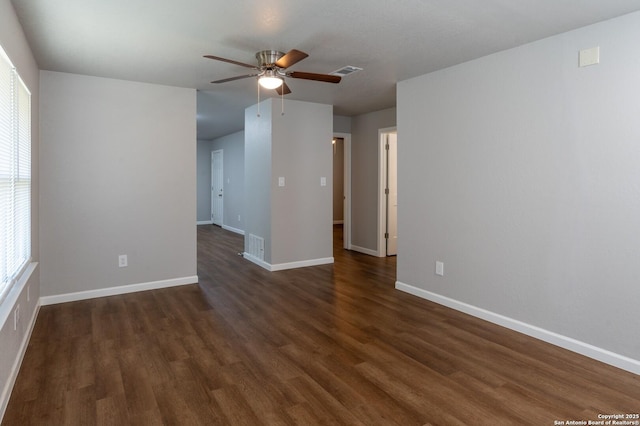 spare room with ceiling fan and dark hardwood / wood-style flooring